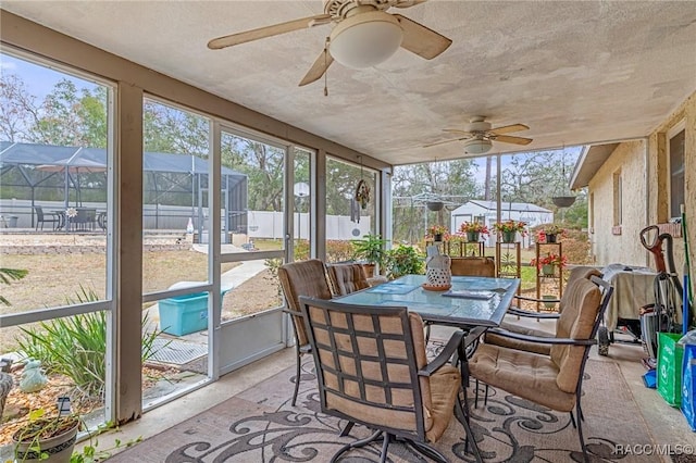 sunroom featuring ceiling fan