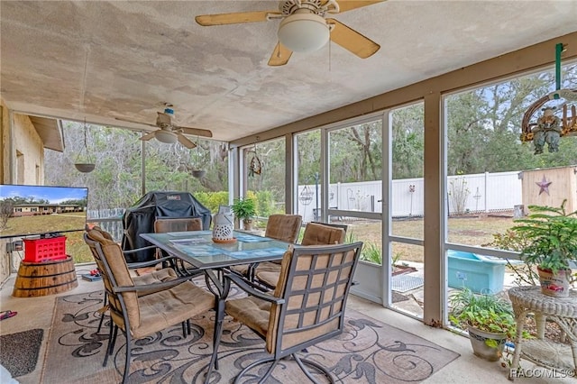 sunroom / solarium with ceiling fan and a healthy amount of sunlight