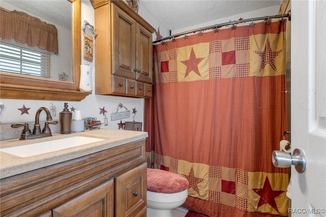 bathroom with vanity, toilet, a textured ceiling, and a shower with curtain