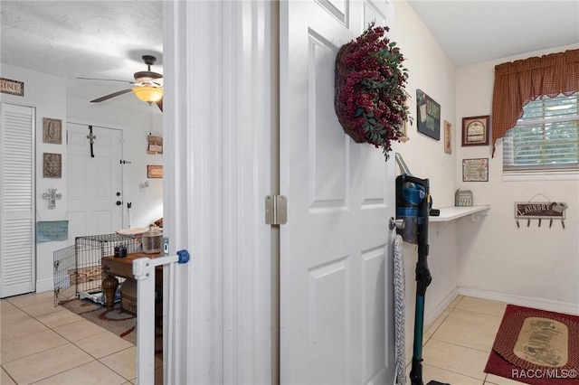 interior space with ceiling fan and light tile patterned floors