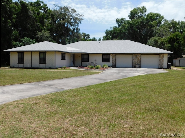 single story home featuring a garage and a front lawn