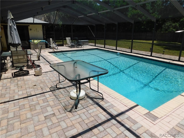 view of pool with a lanai and a patio