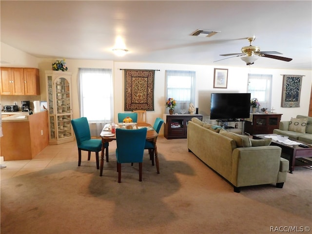 carpeted living room featuring a wealth of natural light and ceiling fan