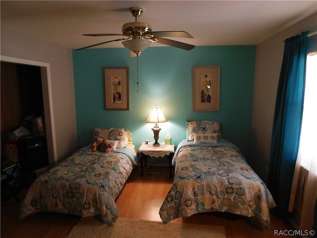 bedroom with ceiling fan and light hardwood / wood-style flooring