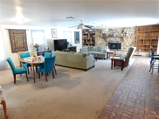 living room with carpet, built in features, and ceiling fan