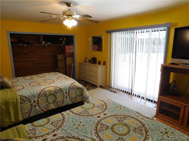 bedroom with ceiling fan and a closet