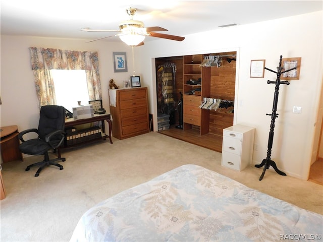 carpeted bedroom with a closet and ceiling fan