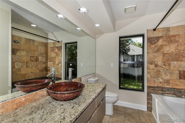 full bathroom featuring tiled shower / bath, tile patterned flooring, vanity, and toilet