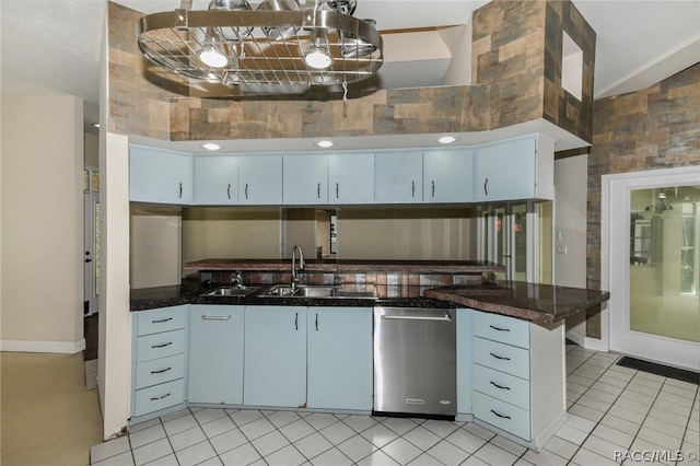 kitchen featuring white cabinetry, stainless steel dishwasher, blue cabinets, decorative light fixtures, and light tile patterned floors