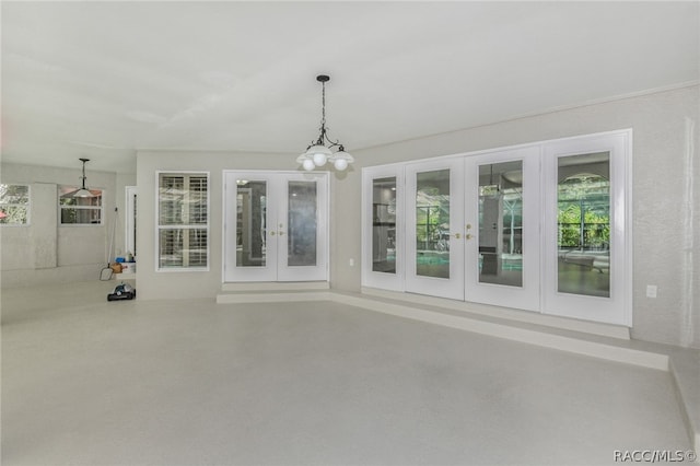 interior space featuring french doors and a notable chandelier