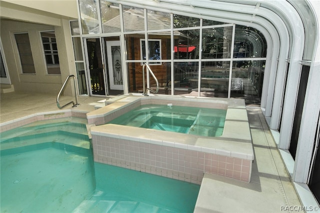 view of swimming pool featuring an in ground hot tub