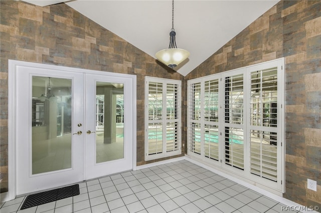 unfurnished sunroom featuring vaulted ceiling and french doors