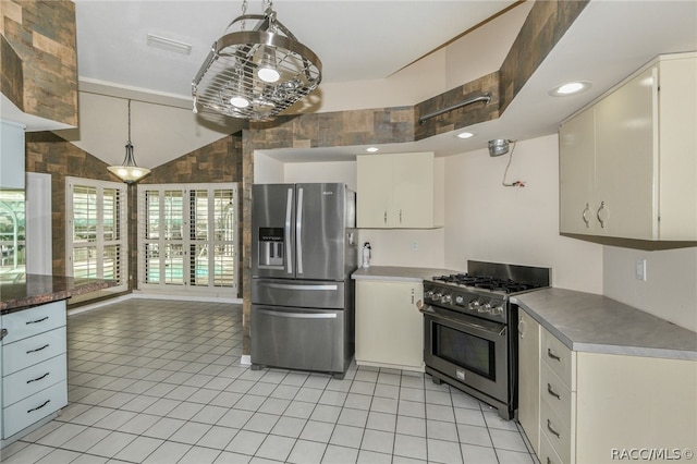 kitchen with light tile patterned flooring, stainless steel appliances, and decorative light fixtures