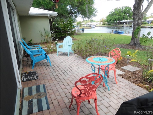 view of patio with a water view