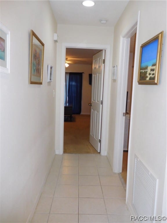 hallway featuring light tile patterned floors