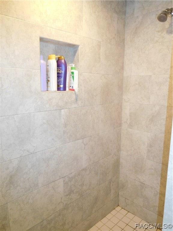 bathroom with tiled shower