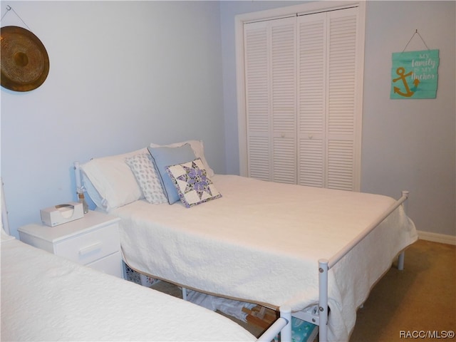 carpeted bedroom with a closet