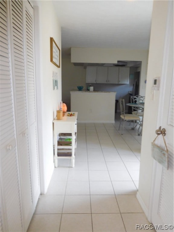 corridor featuring light tile patterned floors