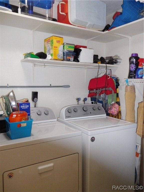 clothes washing area featuring washing machine and clothes dryer