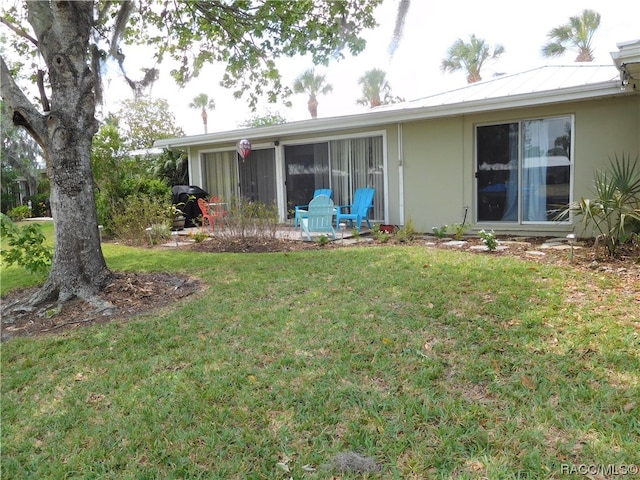 rear view of house with a yard