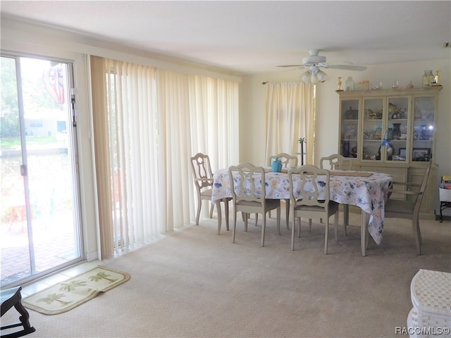 carpeted dining area featuring ceiling fan