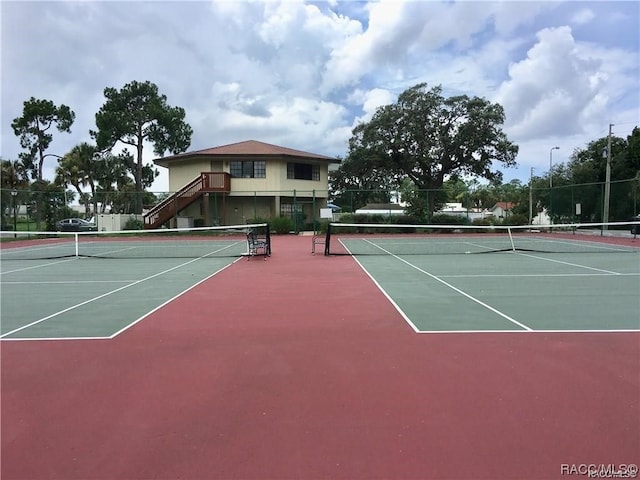 view of tennis court with basketball hoop