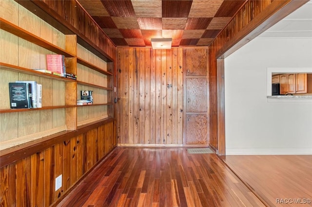 218 N Osceola Ave, Inverness, FL 34450 - spare room featuring wood walls, dark wood-style flooring, and wooden ceiling