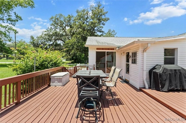 218 N Osceola Ave, Inverness, FL 34450 - wooden deck with outdoor dining area and a grill