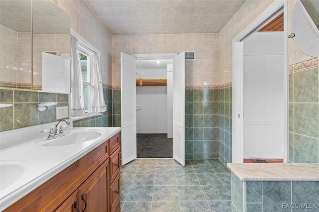 218 N Osceola Ave, Inverness, FL 34450 - full bath featuring tile walls, double vanity, and tile patterned flooring