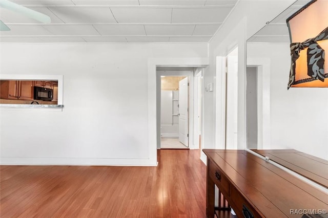 218 N Osceola Ave, Inverness, FL 34450 - corridor with light wood-style floors and baseboards