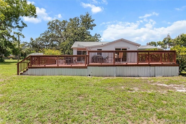 218 N Osceola Ave, Inverness, FL 34450 - back of house featuring a wooden deck and a lawn