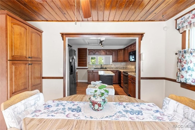 218 N Osceola Ave, Inverness, FL 34450 - dining space with wooden ceiling, light wood finished floors, and attic access