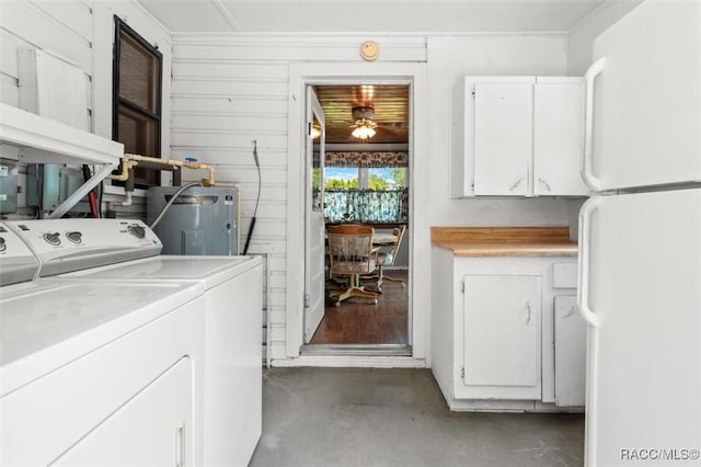 218 N Osceola Ave, Inverness, FL 34450 - laundry area with washing machine and clothes dryer, water heater, and cabinet space