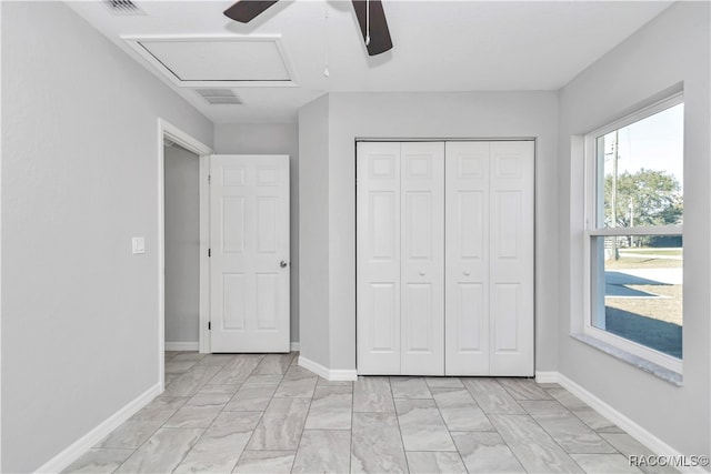 unfurnished bedroom featuring a closet and ceiling fan