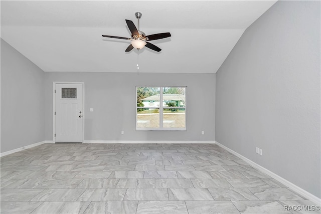 spare room featuring ceiling fan and vaulted ceiling