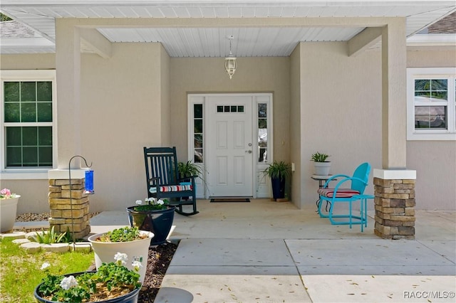 doorway to property with stucco siding