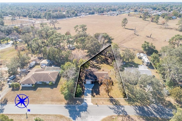 birds eye view of property with a rural view