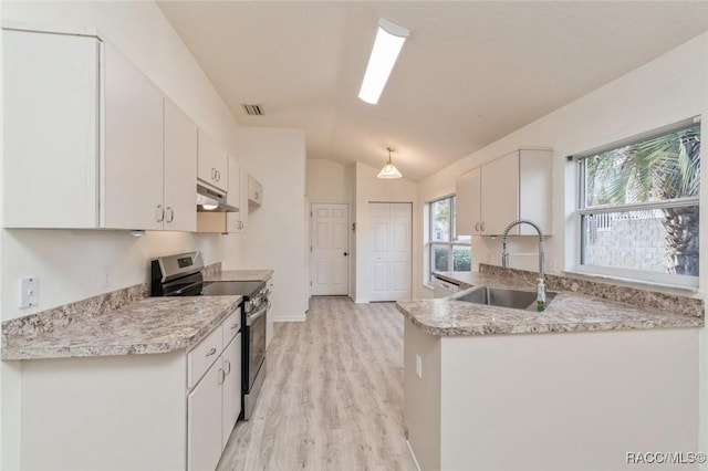 kitchen with lofted ceiling, sink, white cabinetry, decorative light fixtures, and stainless steel range with electric cooktop