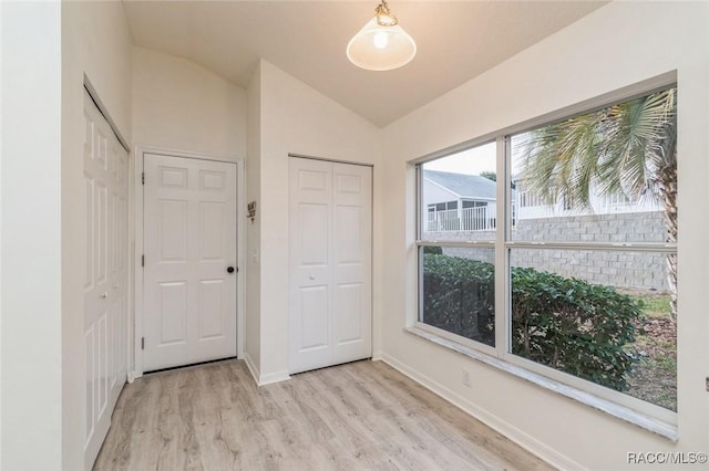 interior space with vaulted ceiling and light wood-type flooring