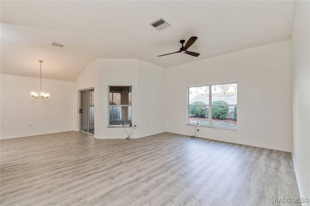 unfurnished living room with ceiling fan with notable chandelier, vaulted ceiling, and light hardwood / wood-style floors