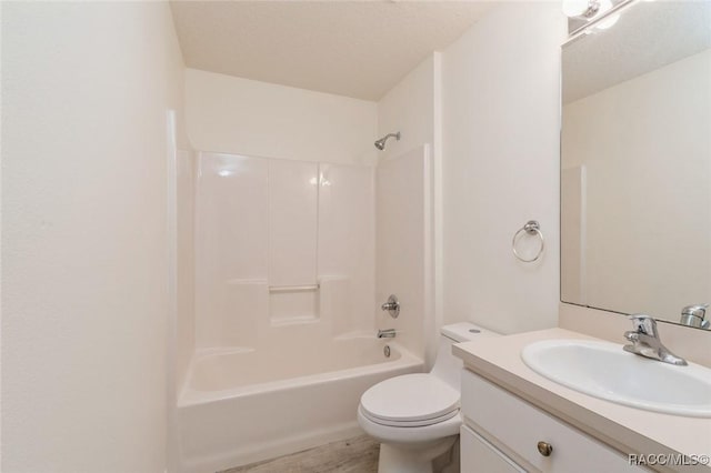 full bathroom featuring vanity, tub / shower combination, and toilet