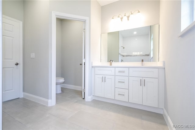 bathroom featuring walk in shower, tile patterned flooring, vanity, and toilet