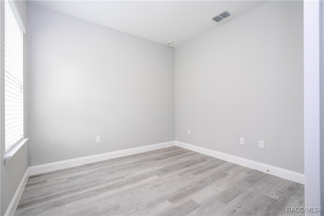 empty room with light hardwood / wood-style flooring