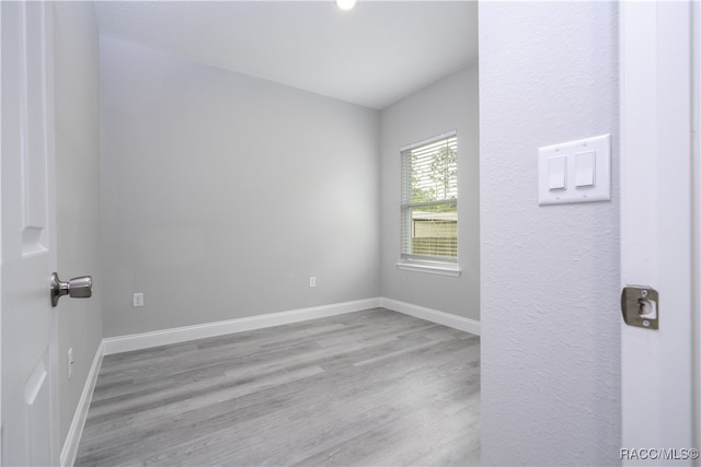 empty room with light hardwood / wood-style floors