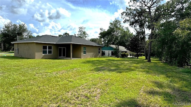 back of property featuring a lawn