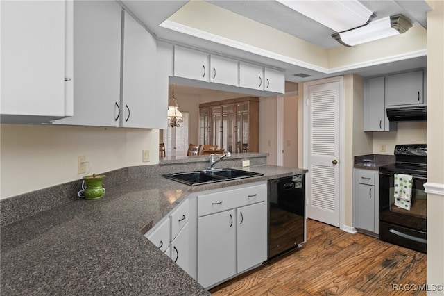 kitchen featuring black appliances, white cabinets, a raised ceiling, sink, and hardwood / wood-style flooring