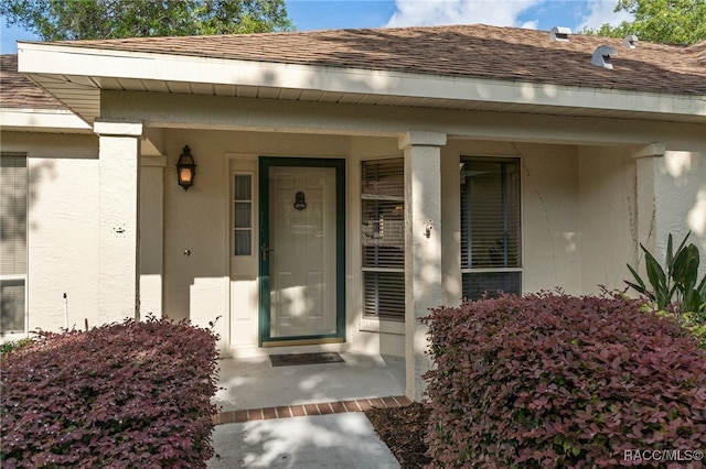 view of exterior entry with a porch