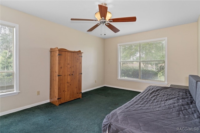 carpeted bedroom featuring ceiling fan and multiple windows