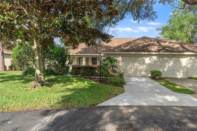 ranch-style house featuring a front yard and a garage