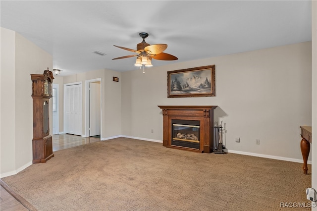 unfurnished living room with ceiling fan and light carpet